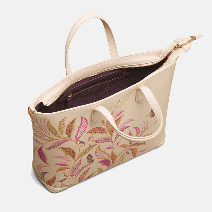 Shows the inside of the bag, with soft plum lining and delicate leaves pattern and internal zip pocket.