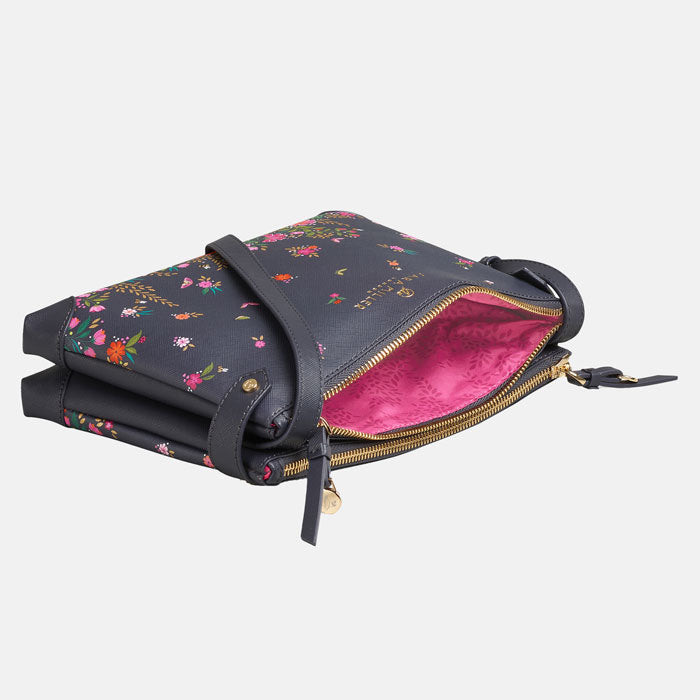 Ditsy floral crossbody bag flat and open to see pink lining inside. can see double zip pocket design.