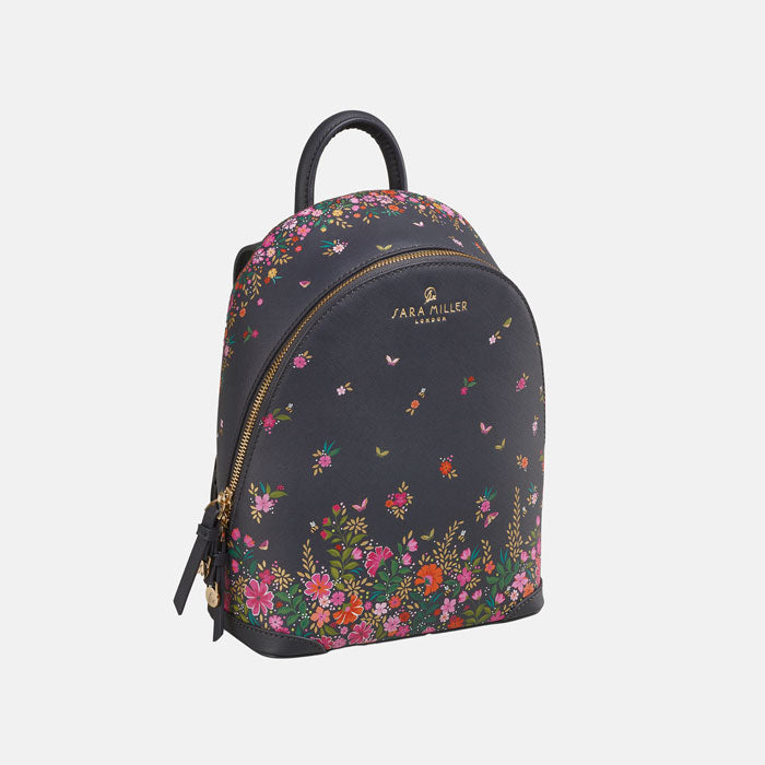 Ditsy floral mini backpack from front/side, white background.