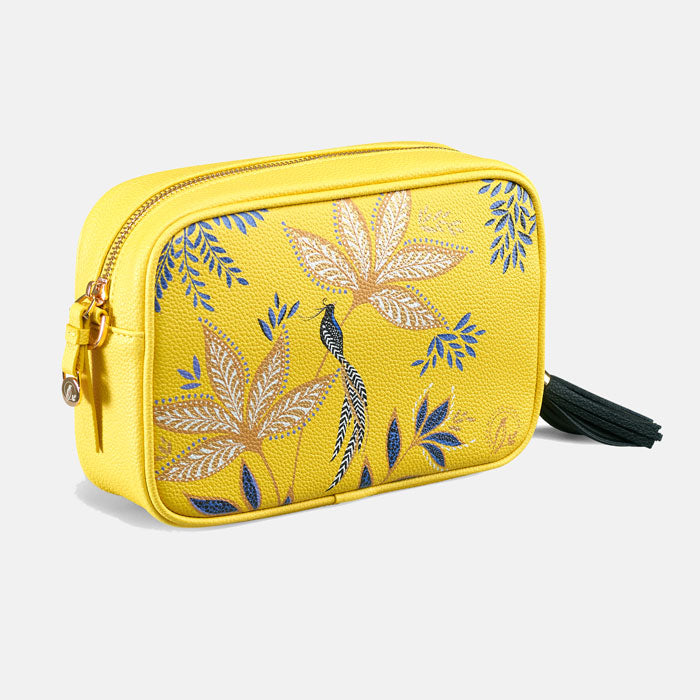 Yellow crossbody handbag with floral design and black tassel.
