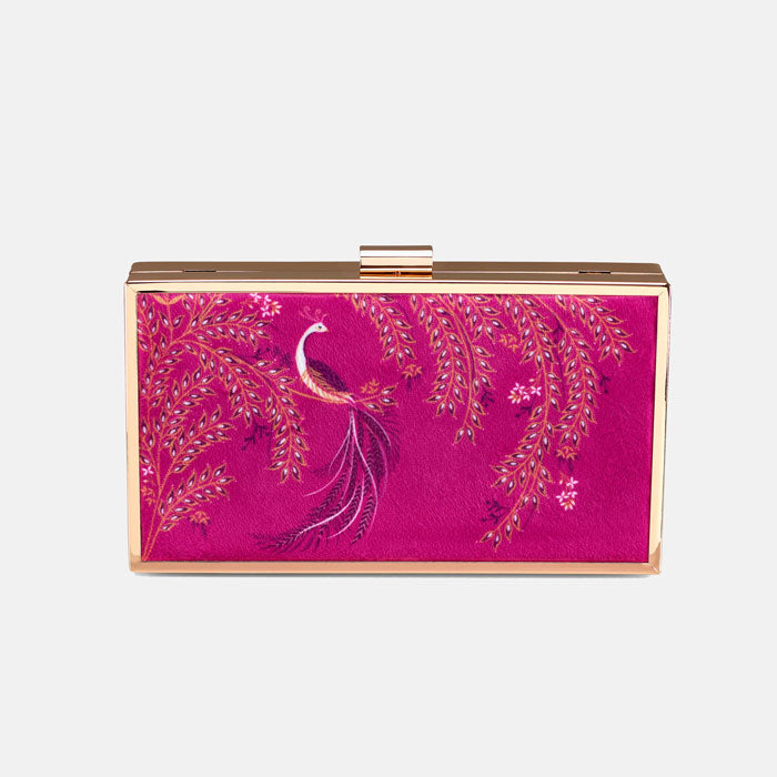 Pink clutch bag with peacock design and gold chain on a pink backdrop