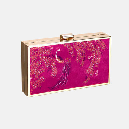 Pink clutch bag with peacock design and gold chain on a pink backdrop