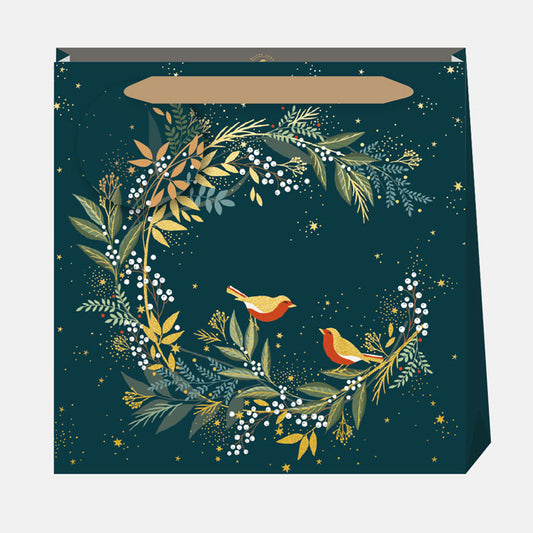 Decorative gift bag with floral design and robins on a dark green background