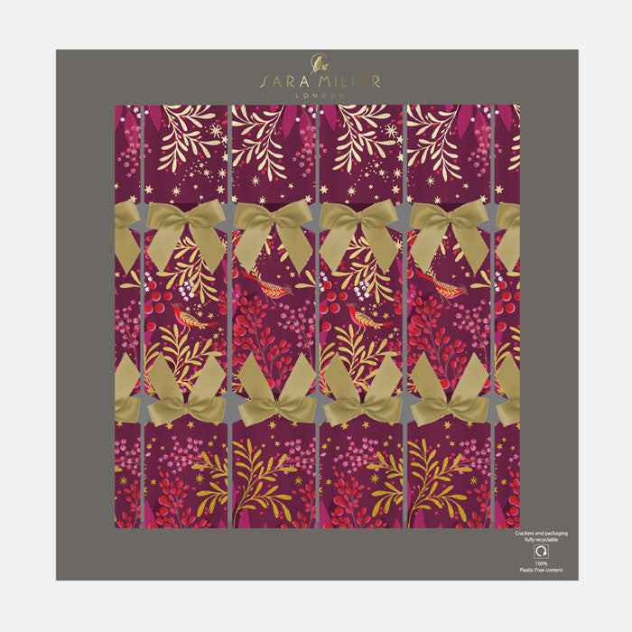 A box of plum Christmas crackers with winter foliage, berries and robins finished with gold ribbons. 