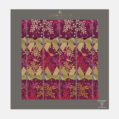 A box of plum Christmas crackers with winter foliage, berries and robins finished with gold ribbons. 