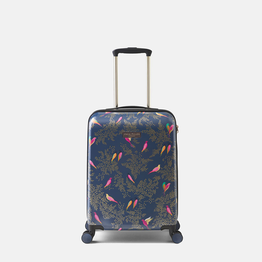 A navy blue hardshell suitcase with colourful pink, yellow, and green bird motifs, featuring an extended telescopic handle and dual spinner wheels.
