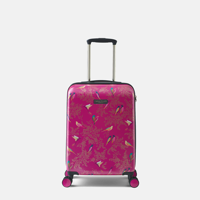 A hard-shell carry-on suitcase in bright pink with a detailed bird and floral pattern, featuring a telescopic handle and four spinner wheels.