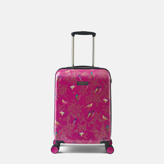 A hard-shell carry-on suitcase in bright pink with a detailed bird and floral pattern, featuring a telescopic handle and four spinner wheels.