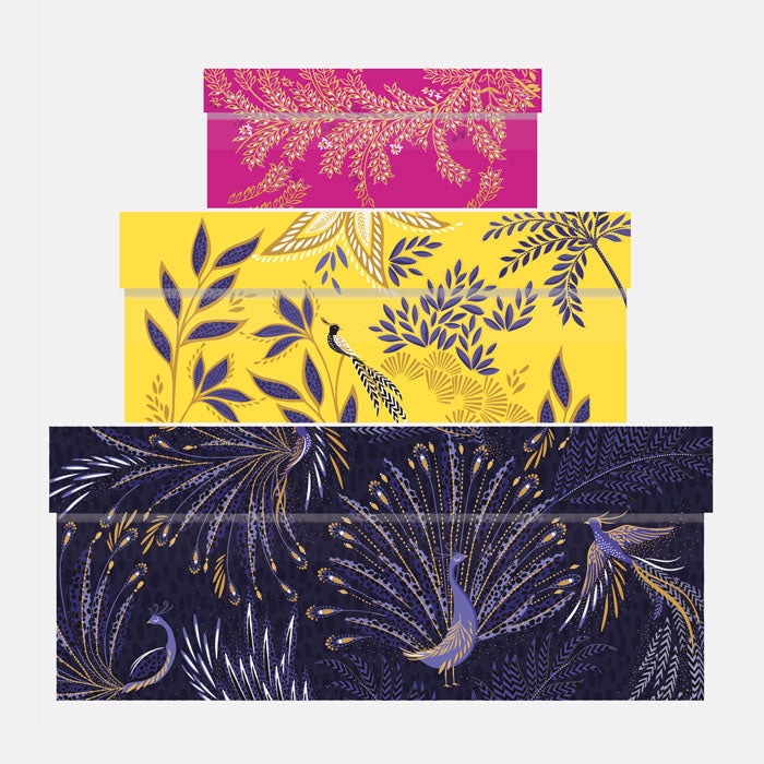 Three stacked gift boxes in different colours, fuchsia, yellow and indigo, in different floral and bird designs.