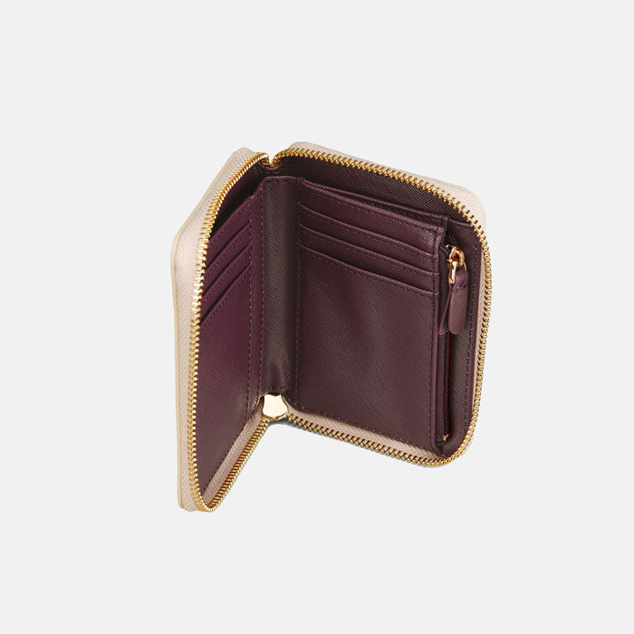 Inside of purse, plum interior, zip pocket and card slots.