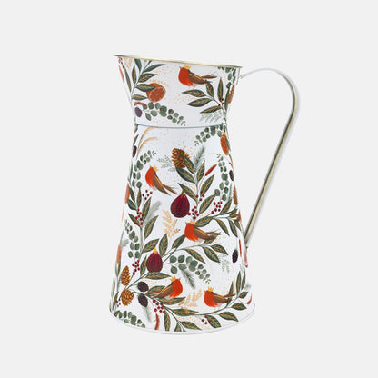 A cream tin flower jug with festive foliage, figs and robins in rich greens and reds.