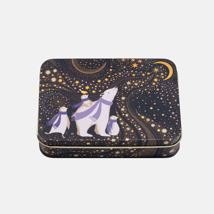 A rectangular metal tin with rounded corners, featuring a whimsical winter night sky design. The design has a dark navy blue background filled with gold stars, a gold crescent moon, and a polar bear family with purple scarves.