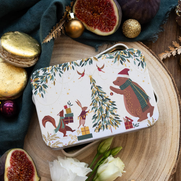 A rectangular tin with rounded corners, decorated with a festive Christmas illustration featuring a bear, squirrel, rabbit, tree, and birds on a cream background. 