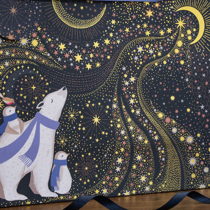 Close up of gift bag, can see textured finish and gold embellished details. 