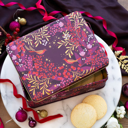 A plum tin with festive berry and foliage design with robins and gold embellishment, pink and reds.