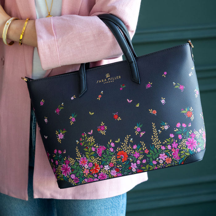 Model wearing ditsy floral medium tote bag. Can see length of straps and scale.