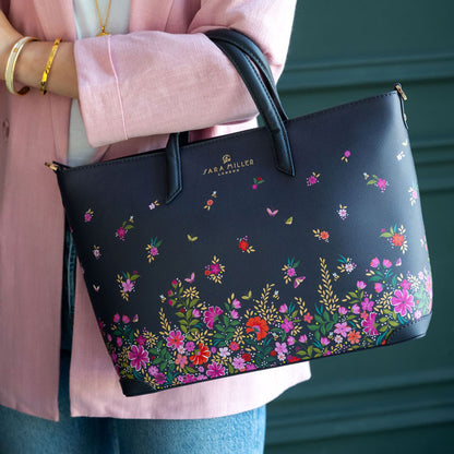 Model wearing ditsy floral medium tote bag. Can see length of straps and scale.