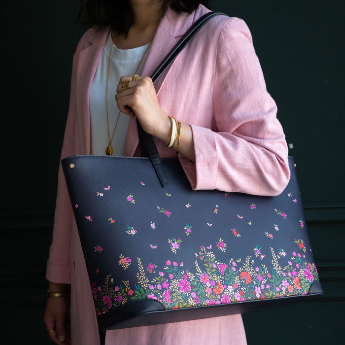 Model wearing bag with complementing pink tones in outfit. Shows scale.
