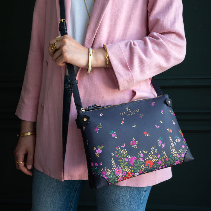 Model wearing ditsy floral crossbody bag, can see scale.