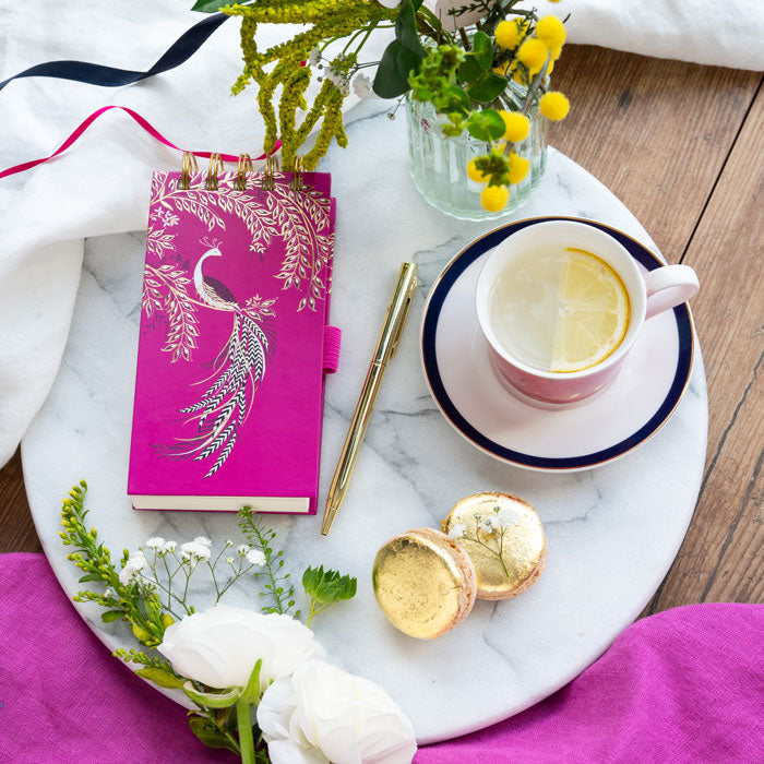 Fuchsia notepad and gold pen set with elegant bird design, gold embellishments.