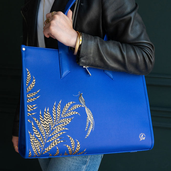 Blue Boxy Tote bag worn by model, moody colours in background.