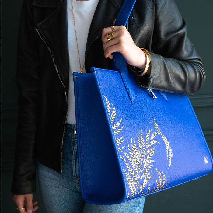 Model wearing blue botanic tote bag.