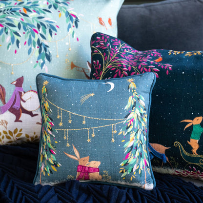 Decorative pillows with festive designs on a dark surface