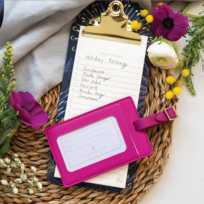 Back of luggage tag, shows space for name, email and phone number. Buckle fastening.