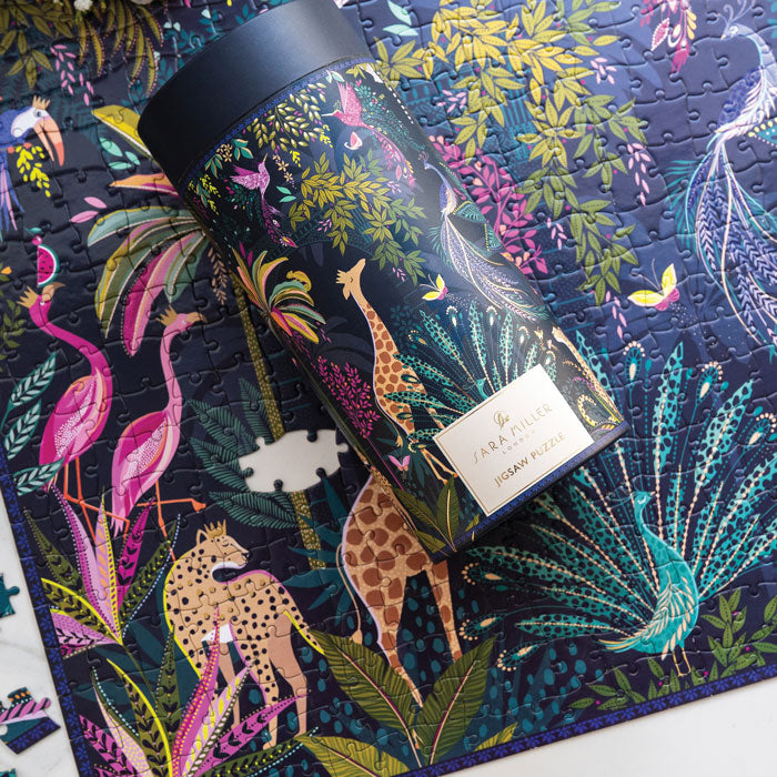 Colourful jungle themed puzzle with animals and foliage. Shows tube style box that it comes in with matching print.