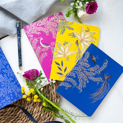 Set of three notebooks with different  botanic, butterflies and peacock designs, in cobalt, yellow and fuchsia.