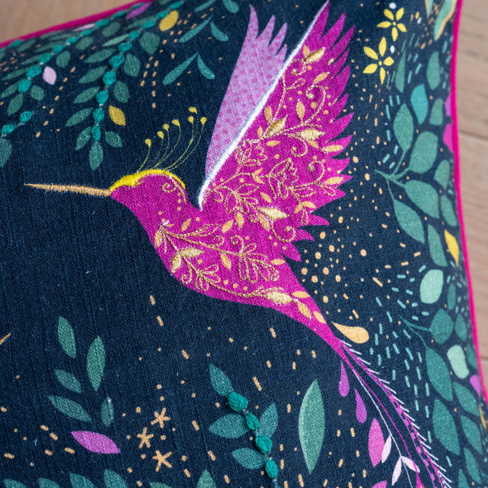 Close up of hummingbird with embroidery and linen texture.