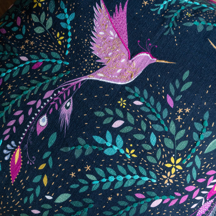Close up of hummingbird with embroidery and linen texture.