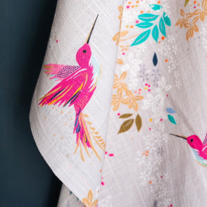 Grey tea towel with hummingbird design.