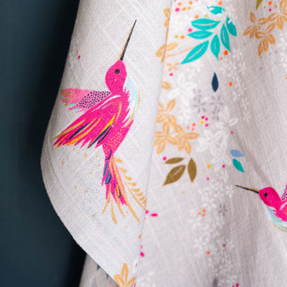 Grey tea towel with hummingbird design.