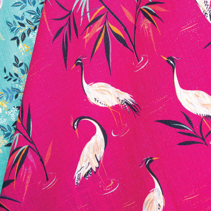 Pink tea towel with heron design.