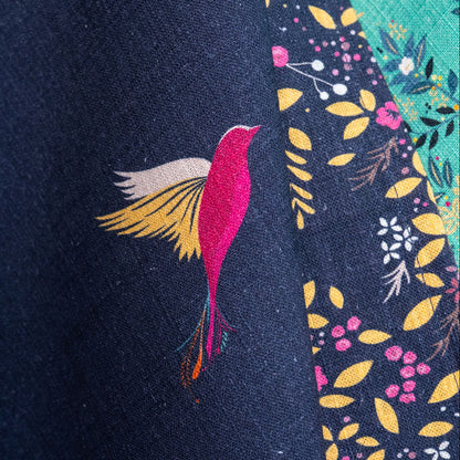 Close up of navy tea towel with hummingbird design.