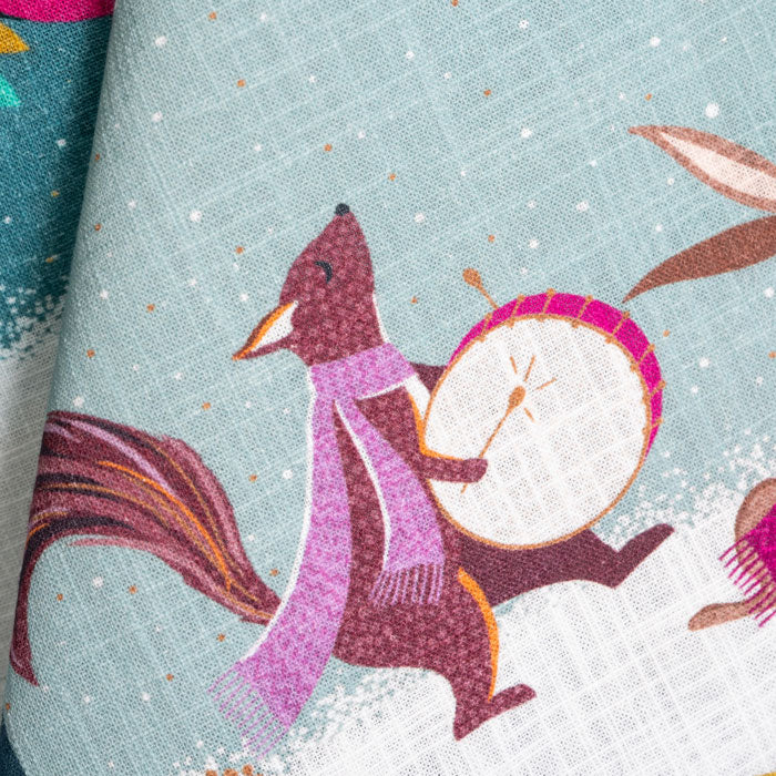 Tea towel with a fox playing a drum on a snowy background