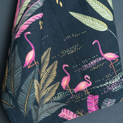 Navy tea towel with flamingo and palm design.