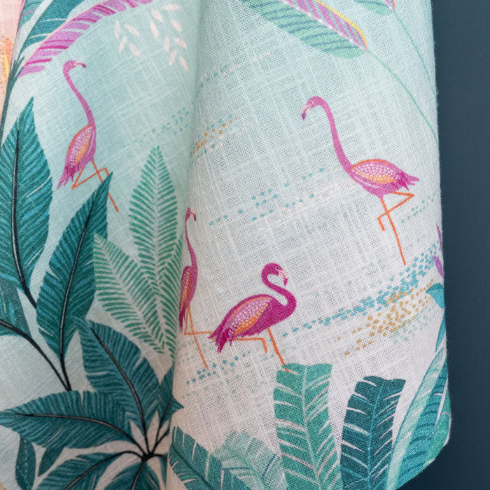 Pink and blue tea towel with flamingos and palms design.