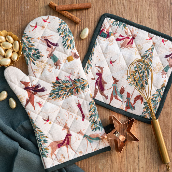 Christmas themed oven mitt and pot holder set with festive animals and trees.