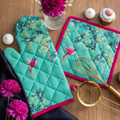 Green oven mit and pot holder with hummingbird and foliage design.