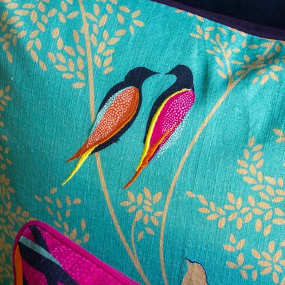 Close up of embroidered birds and linen texture.