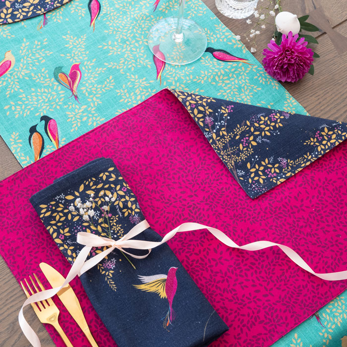 Reverse of placemat, pink with delicate leaves design.