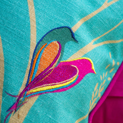 Close up of embroidered birds and linen texture.