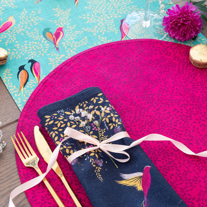 Reverse of placemat, pink with delicate leaves design.