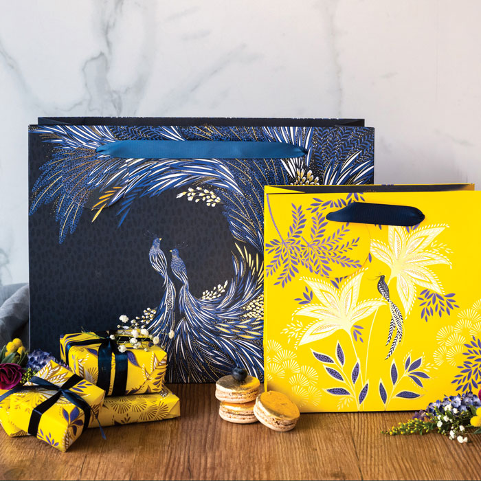 Two gift bags, one yellow and one indigo from the anniversary collection.