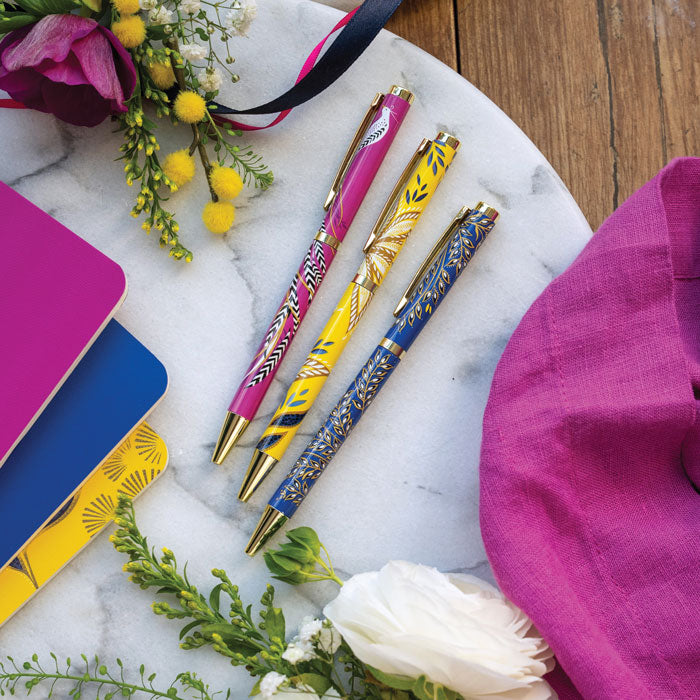 Set of three pens, one yellow, one cobalt and one fuchsia all in different floral designs.