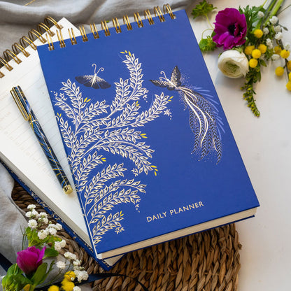 Blue daily planner with butterfly design on a cobalt blue background.