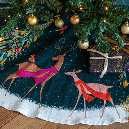 Christmas tree skirt with deer and robins and trees on a dark green background
