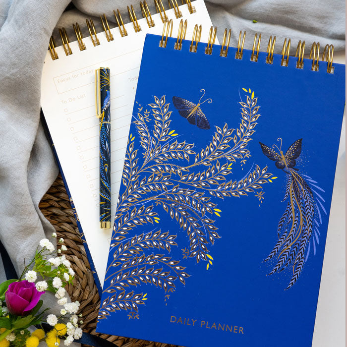 Blue daily planner with butterfly design on a cobalt blue background.